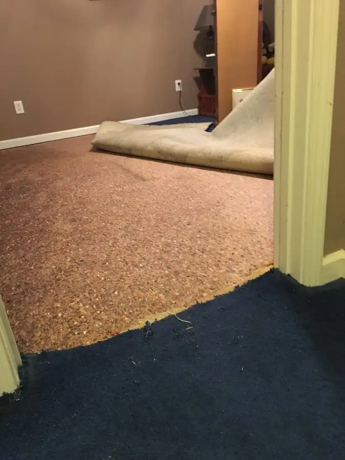 Carpet pad removal revealing water damage during Water Mitigation Services in Grover Beach